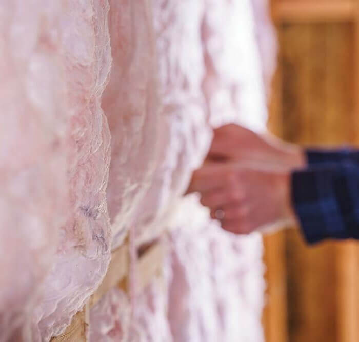 man touching new insulation