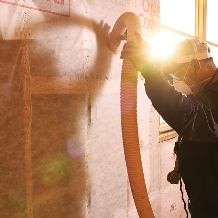 man blowing wool in wall