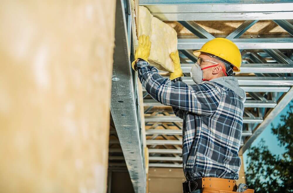 Man installing mineral wool