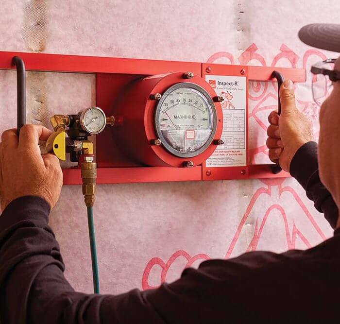 Technician working on dial of red Inspect-R