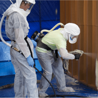 team members spraying insulation