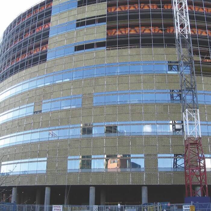 exterior view of building in the process of installing ROCKWOOL ROXUL Safe® semi-rigid stone wool insulation