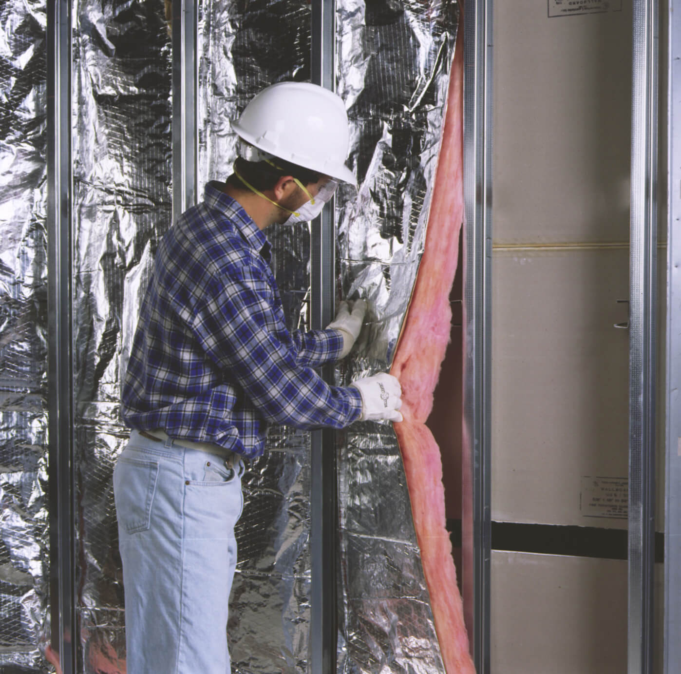 Man installing a row of faced insulation