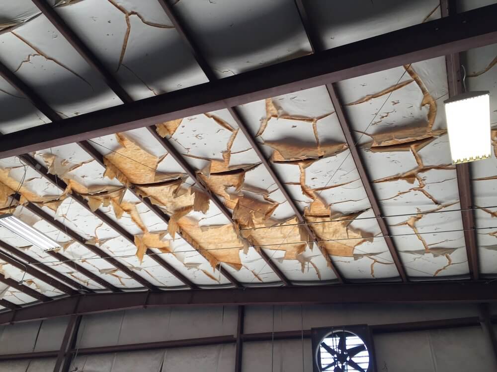 ripped and torn vinyl facing insulation in metal building