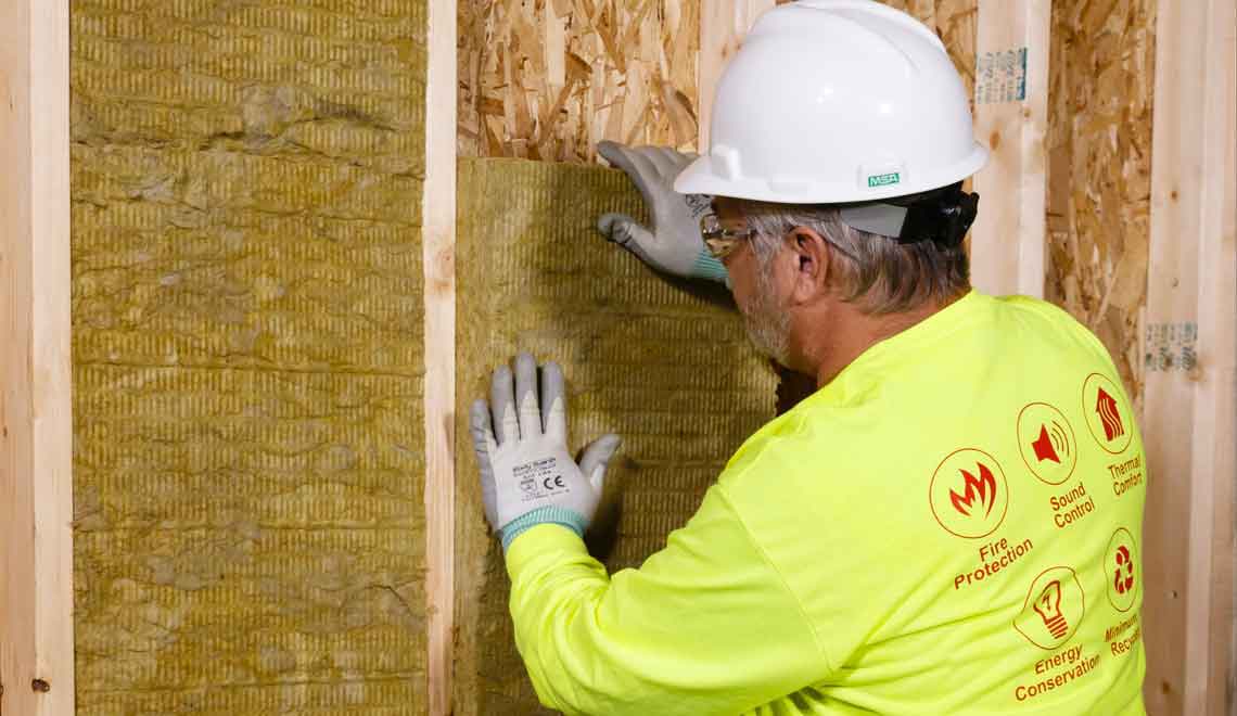 Man installing mineral wool