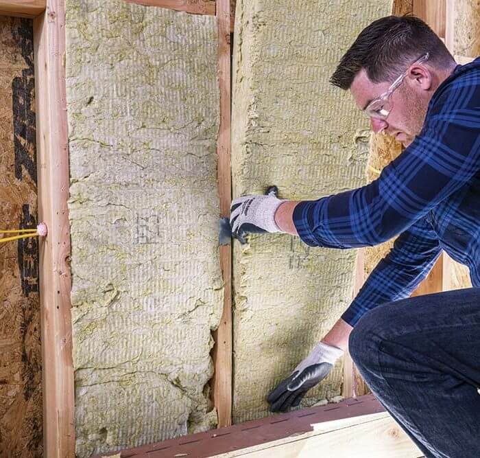 man installing insulation