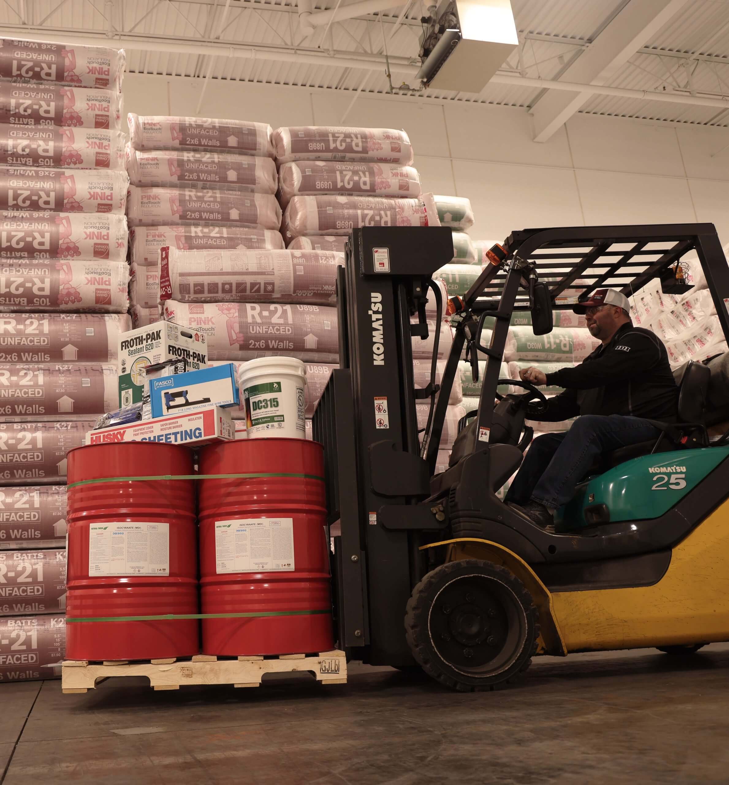 A forklift next to a large stack of batting