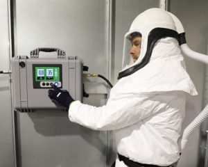 man in coveralls and respirator hood using air guard