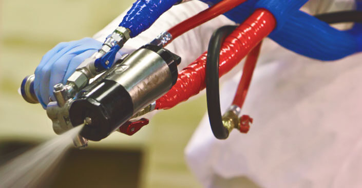 Close-up shot of spray coming out of held spray nozzle