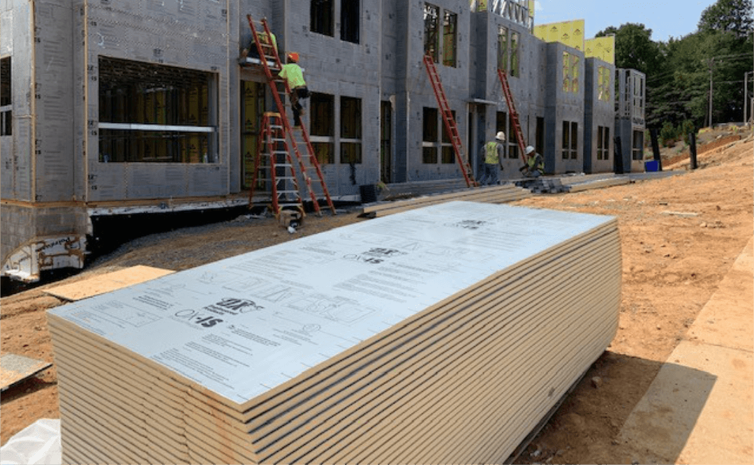 Close-up stack of sheets foam board sitting outside construction site