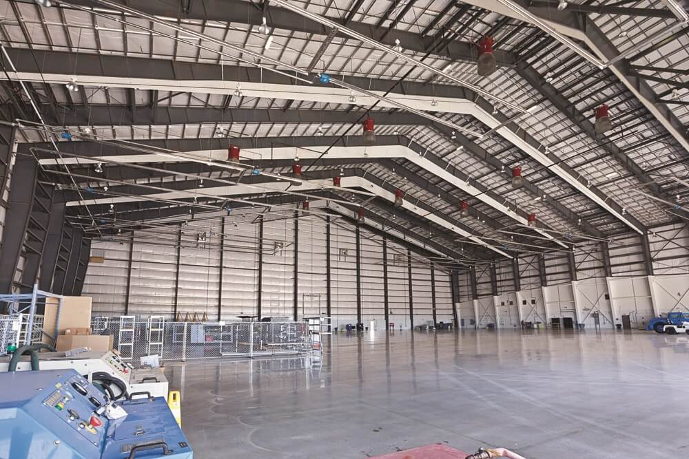 Wide shot of large nearly empty storage hangar