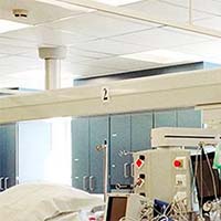 White paneled ceiling and miscellaneous medical equipment