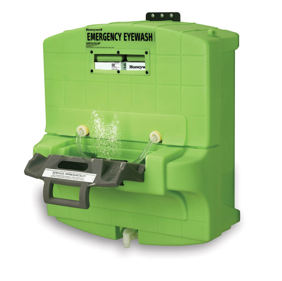 A green emergency eyewash station by Honeywell with water spraying out of the front.
