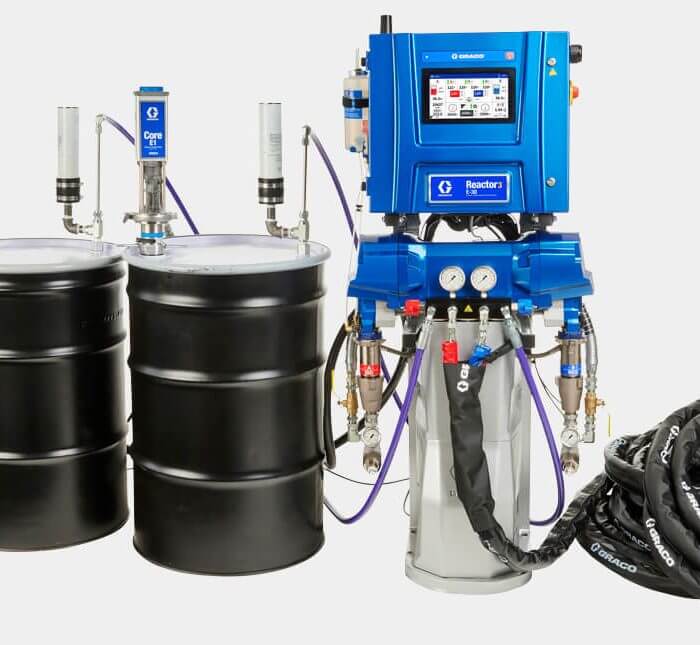 Reactor 3 spray foam system from Graco attached to two black drums