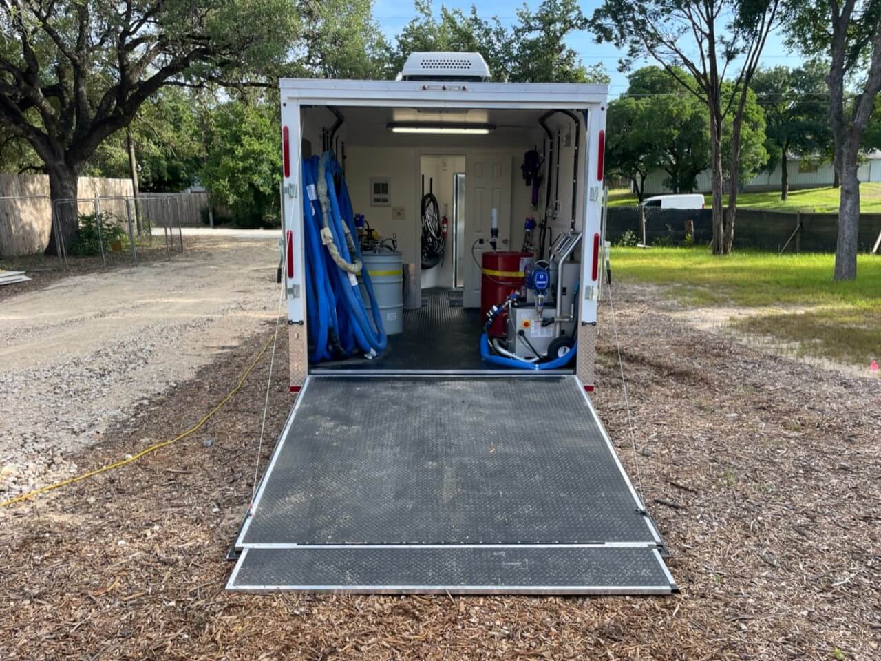 Front view of the Spray Foam Rig with the back door down showing the inside.
