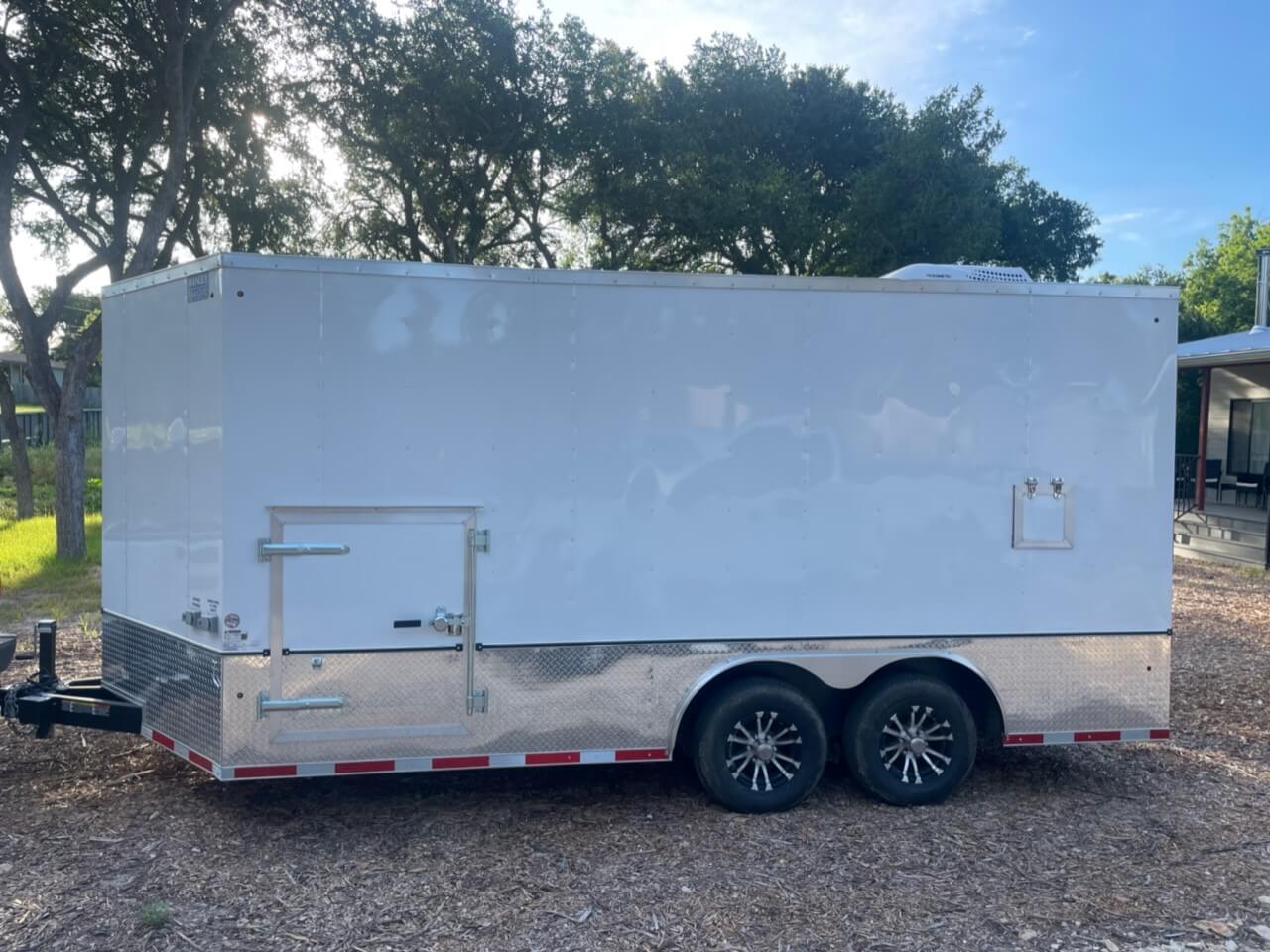 Side Profile of Spray Foam Rig parked outside of a house