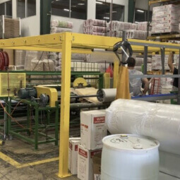 Interior shot of warehouse featuring barrels and pipes