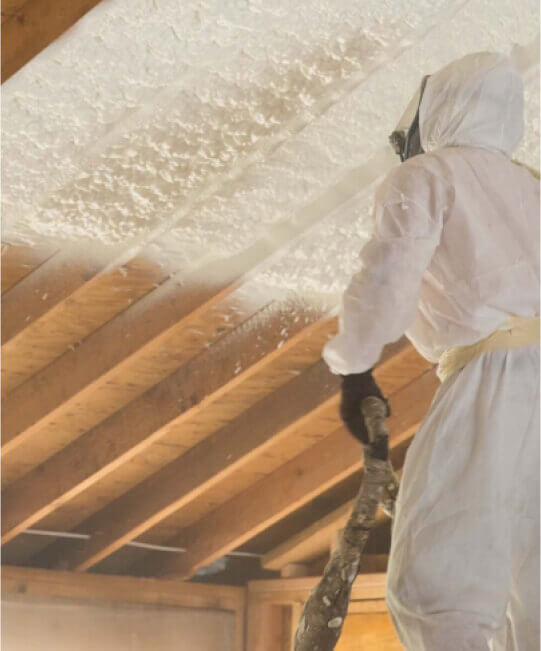 spraying ceiling with spray foam